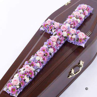 <h2>Extra Large Pink and Lilac Classic Cross-Shaped Design | Funeral Flowers</h2>
<br>
<ul>
<li>Approximate Size W 56cm H 160cm</li>
<li>Hand created extra-large pink and lilac classic cross in fresh flowers</li>
<li>To give you the best we may occasionally need to make substitutes</li>
<li>Funeral Flowers will be delivered at least 2 hours before the funeral</li>
<li>For delivery area coverage see below</li>
</ul>
<br>
<h2>Liverpool Flower Delivery</h2>
<br>
<p>We have a wide selection of Funeral Crosses offered for Liverpool Flower Delivery. Funeral Crosses can be provided for you in Liverpool, Merseyside and we can organize Funeral flower deliveries for you nationwide. Funeral Flowers can be delivered to the Funeral directors or a house address. They can not be delivered to the crematorium or the church.</p>
<br>
<h2>Flower Delivery Coverage</h2>
<br>
<p>Our shop delivers funeral flowers to the following Liverpool postcodes L1 L2 L3 L4 L5 L6 L7 L8 L11 L12 L13 L14 L15 L16 L17 L18 L19 L24 L25 L26 L27 L36 L70 If your order is for an area outside of these we can organise delivery for you through our network of florists. We will ask them to make as close as possible to the image but because of the difference in stock and sundry items it may not be exact.</p>
<br>
<h2>Liverpool Funeral Flowers | Crosses</h2>
<br>
<p>This extra-large classic funeral cross has been loving handcrafted by our expert florists and features a mix of spray chrysanthemums, roses, spray carnations in pinks and lilacs with luscious green foliage to complete this traditional design.</p>
<br>
<p>Funeral crosses are symbols of belief they reaffirm faith and provide comfort at this difficult time.</p>
<br>
<p>In the larger sizes (from 4ft up) they are appropriate as the main tribute but smaller sizes are sometimes chosen by close friends as they represent extremely personal sentiments and feelings.</p>
<br>
<p>Containing 7 pink spray chrysanthemums, 5 lilac september flower, 15 pink short-stem roses, 20 white spray carnations, 8 lilac statice and seasonal mixed foliage.</p>
<br>
<h2>Best Florist in Liverpool</h2>
<p>Trust Award-winning Liverpool Florist, Booker Flowers and Gifts, to deliver funeral flowers fitting for the occasion delivered in Liverpool, Merseyside and beyond. Our funeral flowers are handcrafted by our team of professional fully qualified who not only lovingly hand make our designs but hand-deliver them, ensuring all our customers are delighted with their flowers. Booker Flowers and Gifts your local Liverpool Flower shop.</p>
<br>
<p><em>Janice Crane - 5 Star Review on Google - Funeral Florist Liverpool</em></p>
<br>
<p><em>I recently had to order a floral tribute for my sister in laws funeral and the Booker Flowers team created a beautifully stunning arrangement. Thank you all so much, Janice Crane.</em></p>